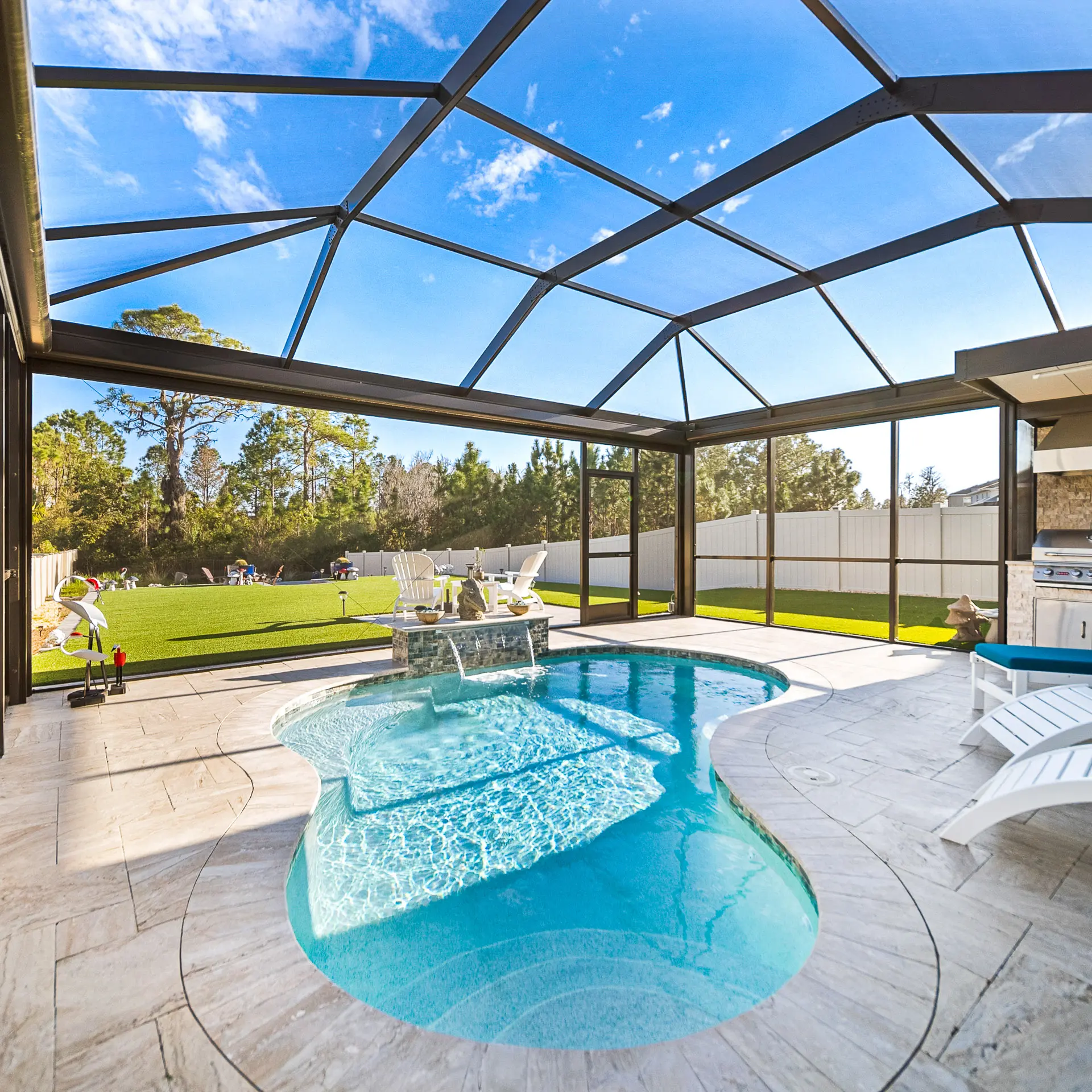 Custom concrete pool with tanning ledge in a Tampa Bay backyard
