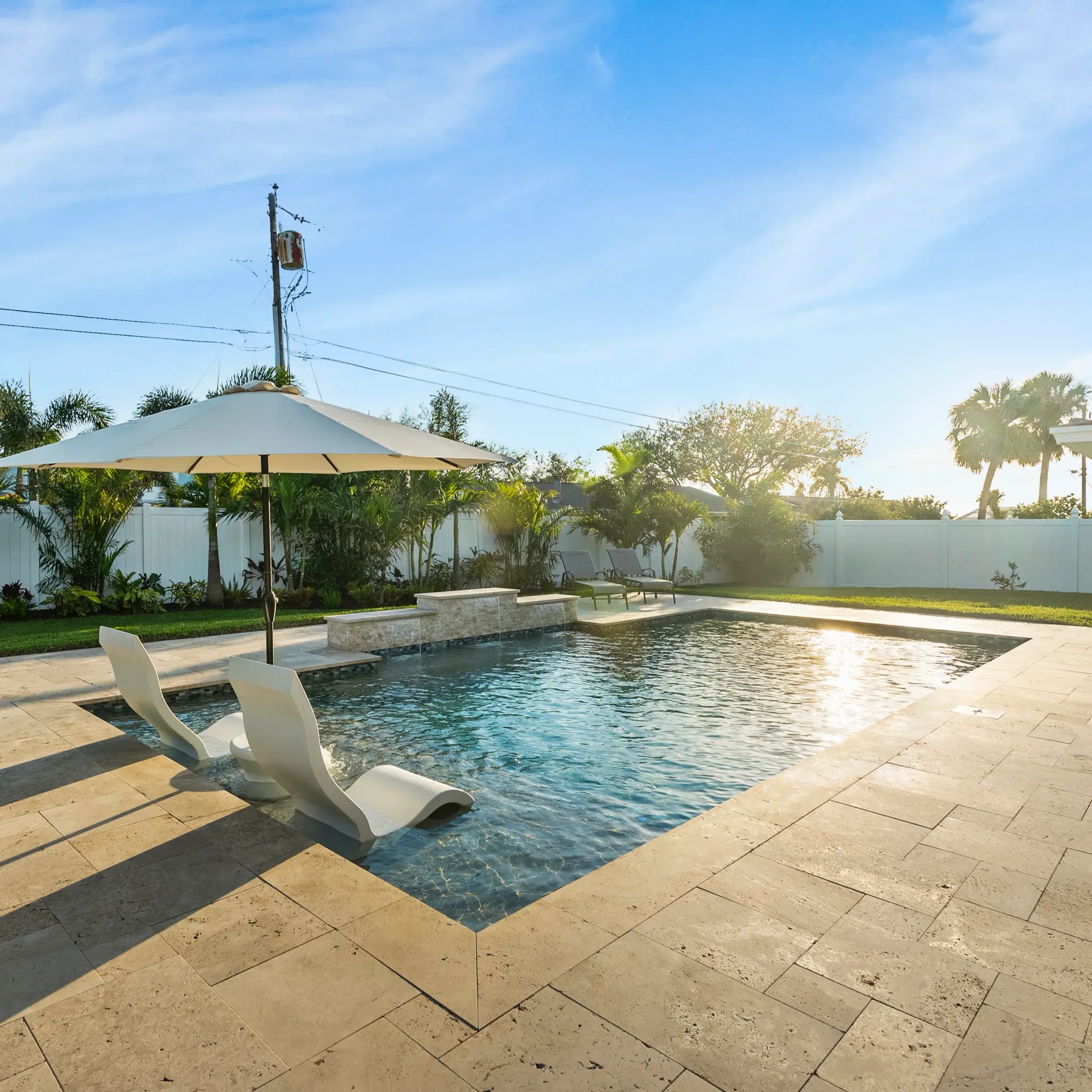 Compact custom concrete cocktail pool in a Tampa Bay backyard