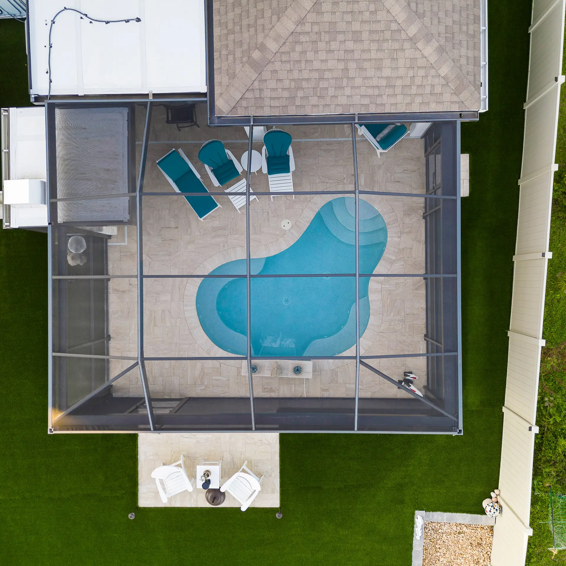 Custom small concrete pool with a tanning ledge in a compact Tampa Bay yard