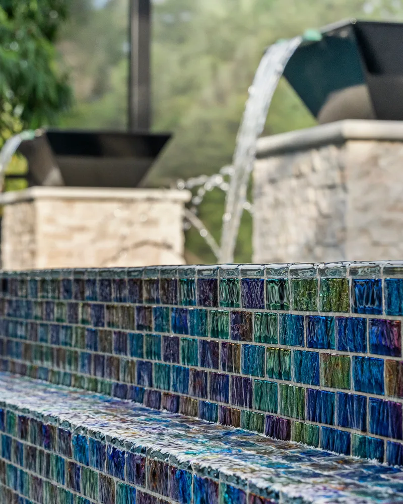 Custom pool with stone pillars, water bowls and deck jets built by Pool Perfection in Tampa