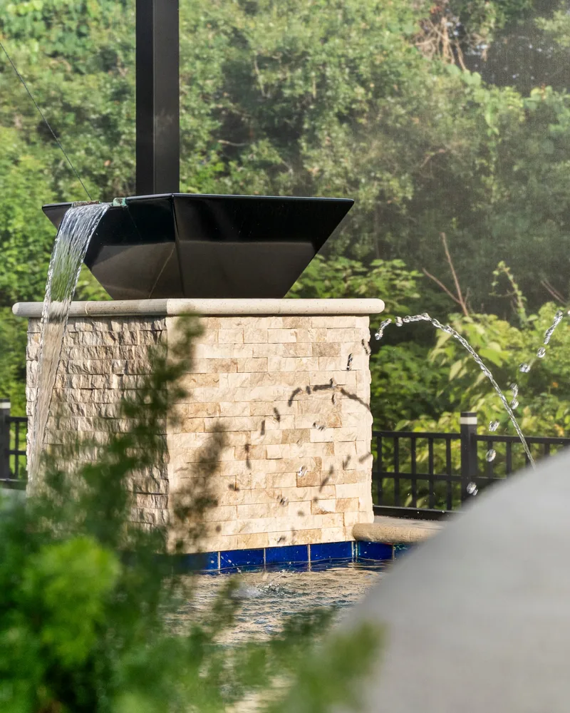Custom pool with stone pillars, water bowls and deck jets built by Pool Perfection in Tampa