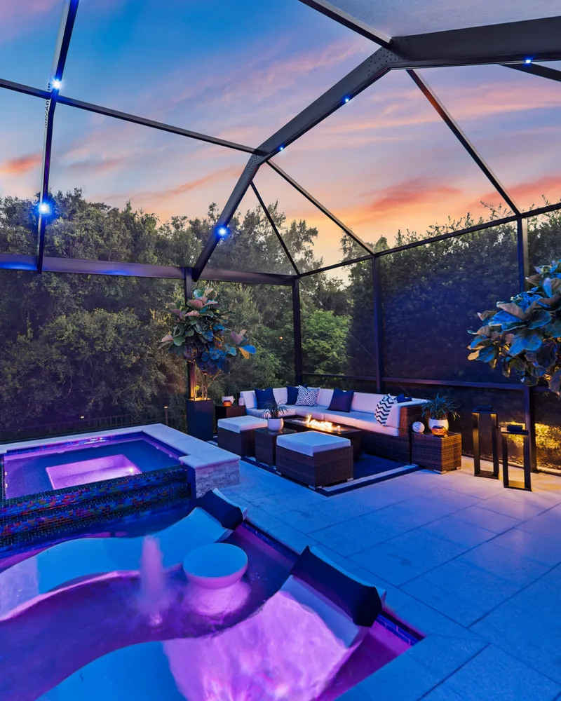 Raised spa finished in iridescent subway tile glowing at sunset
