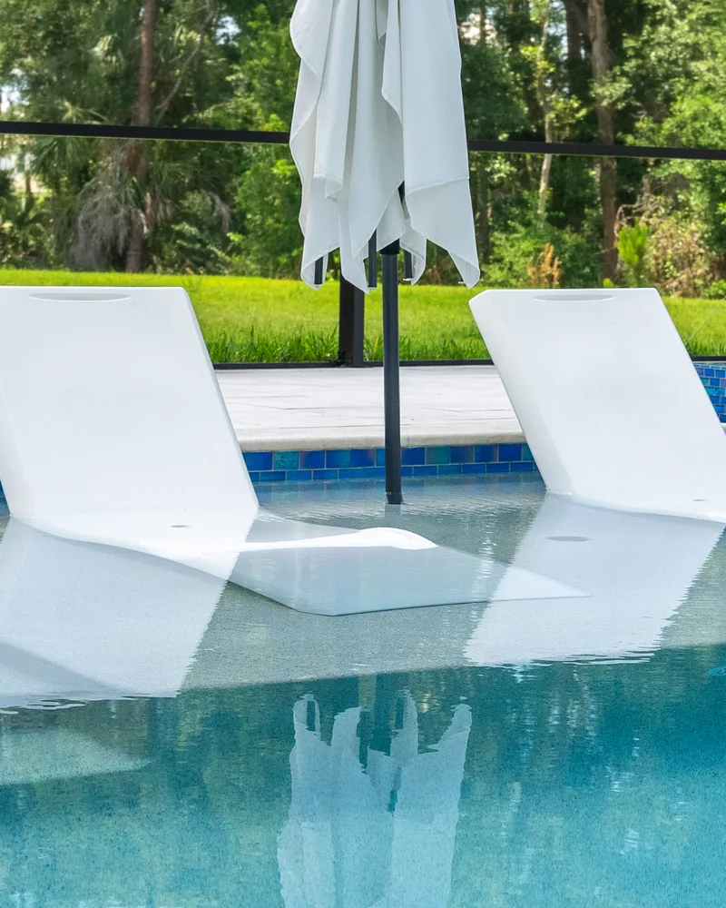 Custom pool and raised spa with Blue Lagoon glass tile built by Pool Perfection in Wesley Chapel