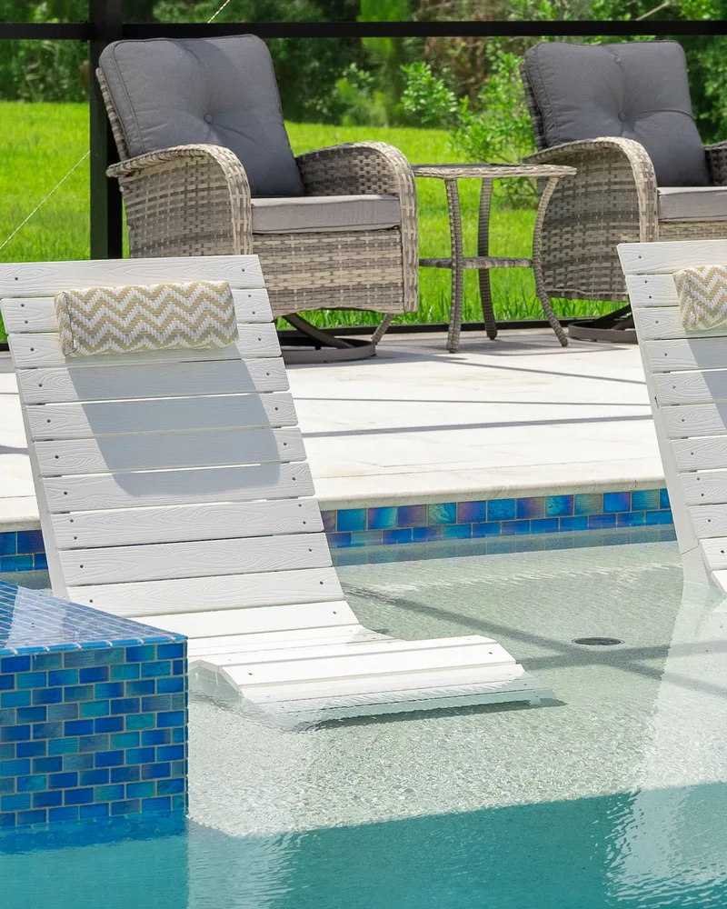 Custom pool and raised spa with Blue Lagoon glass tile built by Pool Perfection in Wesley Chapel